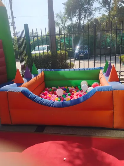 A full view of the empty ball pool, highlighting its bright colors and design before the kids jump in.