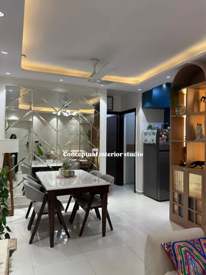This dining area uses a large, custom-designed mirror wall to create an illusion of space, making the room feel open and grand.