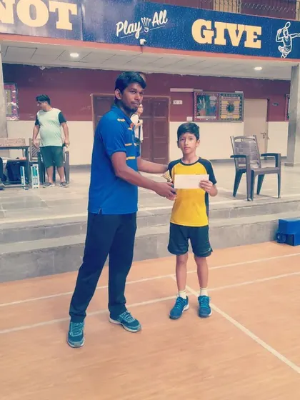 Another shot of the junior player receiving his award, showing his pride in his accomplishment.