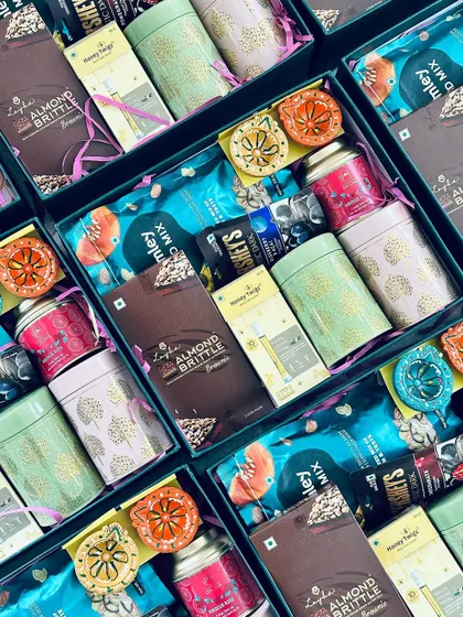 Another perspective of the open Diwali hampers, highlighting the colorful packaging of the included items.