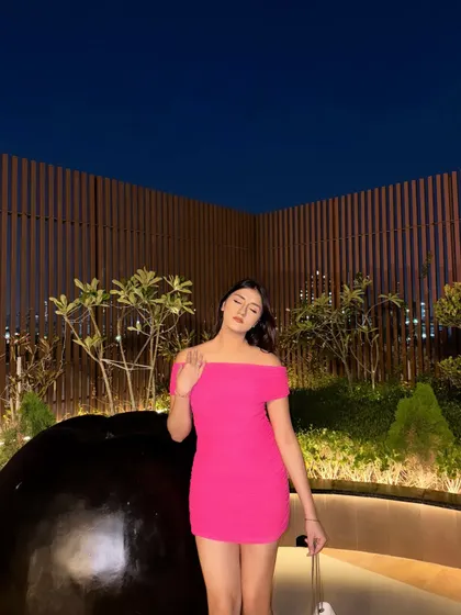 A candid, eyes-closed moment in the pink dress.