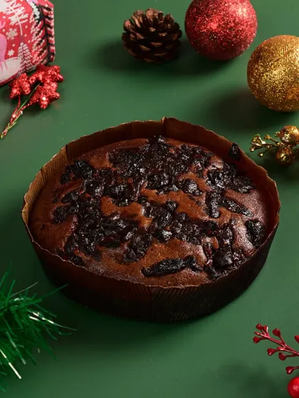 A traditional Christmas plum cake, rich with dried fruits and spices. A festive favorite.