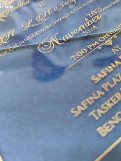 A luxurious blue acrylic wedding reception invitation with gold engraved text, offering a modern and pocket-friendly alternative to traditional cards.