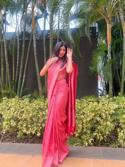 Dressed in a pink saree for wedding season. I love the elegance and grace of traditional Indian wear for festive occasions.