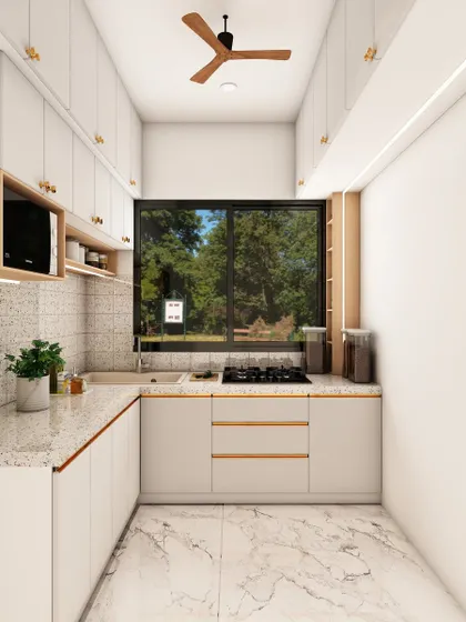 This perspective highlights the large window that fills the space with natural light, making the white kitchen feel even more bright and airy.