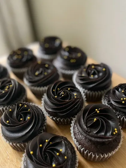 Another look at our rich chocolate cupcakes with gold sprinkles, a classic choice for birthdays and celebrations of all kinds.