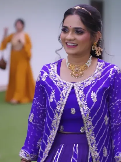 A candid moment of her enjoying the wedding. The hairstyle is a simple half-updo that is both elegant and comfortable.