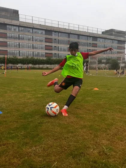 A player mid-strike, demonstrating the kicking technique we teach at the academy.