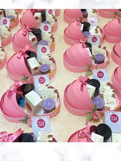 Pretty in pink! Here's a look at a full order of our custom "It's a Girl!" cradle announcement hampers, ready to be delivered.