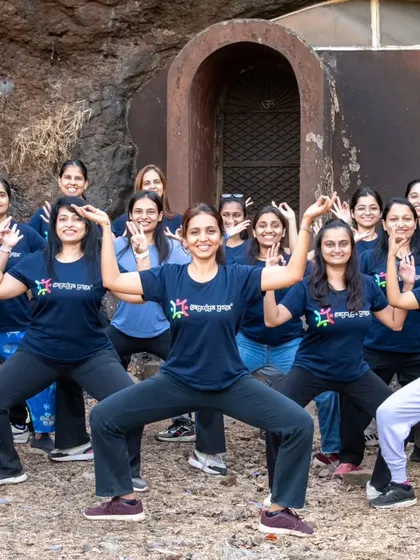 Participants in our Sadhana Retreat practicing Goddess Pose (Utkata Konasana) outside a cave, embodying strength and feminine energy.