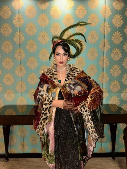 Another portrait showcasing the dramatic feather headpiece and hairstyle. This look demonstrates my ability to execute bold, concept-driven hair artistry for high-profile events.
