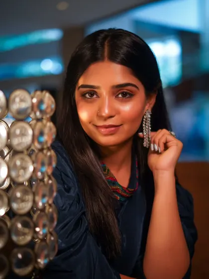 A beautiful, smiling portrait of Gouri, lit softly to create a gentle and glamorous look.