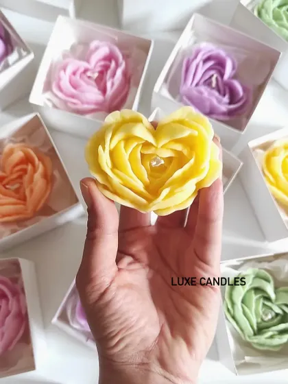 A close-up of the yellow heart-shaped rose candle, showing the intricate petal details. Each one is handcrafted to look like a real rose.
