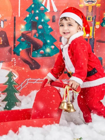 This little Santa is ringing the jingle bells to spread some holiday cheer.