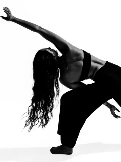A powerful, athletic pose captured in black and white, highlighting the strength of a dancer.