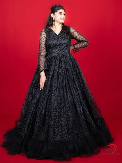 A full portrait view of our elegant black gown with a geometric pattern, a great rental for any formal event.
