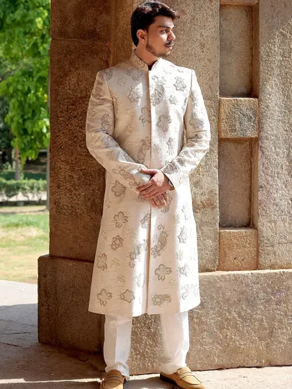 A classic pose in our ivory embroidered sherwani. The full-length view shows the beautiful drape of the fabric and the traditional motifs that make this a timeless piece for any wedding.