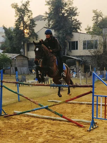 Practice makes perfect. Here, one of our dedicated riders, Reya, trains with her horse Bunting in our sand arena. Our training focuses on building a strong connection and trust between horse and rider to clear any obstacle.