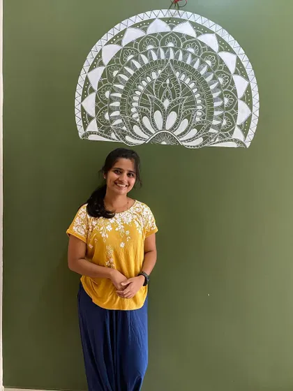 This semi-mandala was uniquely designed to wrap around a corner. The intricate white details on the olive green wall create a beautiful and continuous piece of art that flows from one space to another.