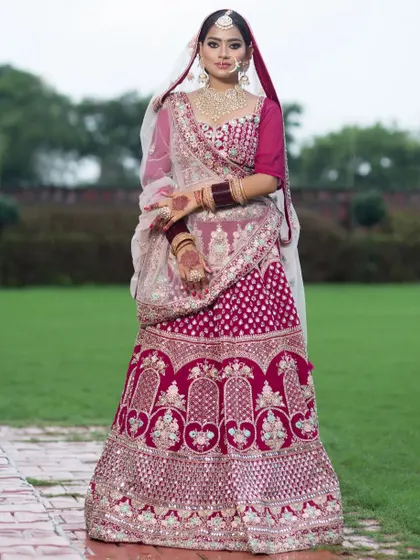 A stunning magenta pink bridal lehenga for the bride who wants a touch of modern color. The heavy silver embroidery makes it perfect for a grand celebration.