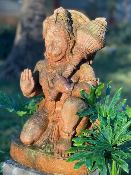 This Lord Hanuman statue, made from sandstone, features strong features and detailed carvings on all sides, making it a great focal point for a garden.