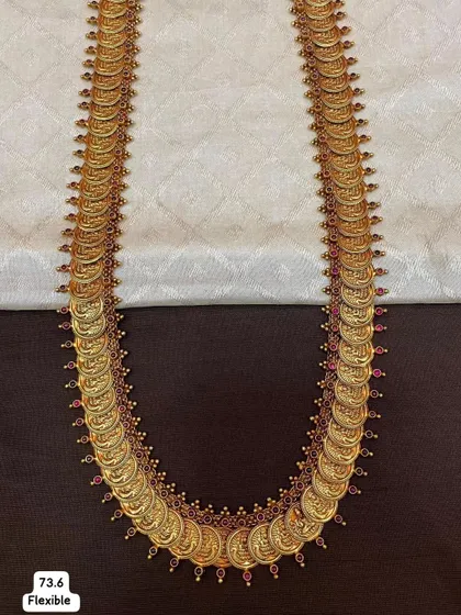 This is a flexible Kasina Sara, or coin necklace, made from 92.5 silver with gold plating. It's a traditional and highly sought-after piece for South Indian brides.
