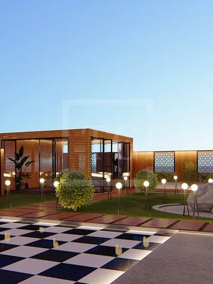 This render of the Gurgaon project showcases a central lawn with a rock feature, a glass house for seating, and dramatic globe lighting.