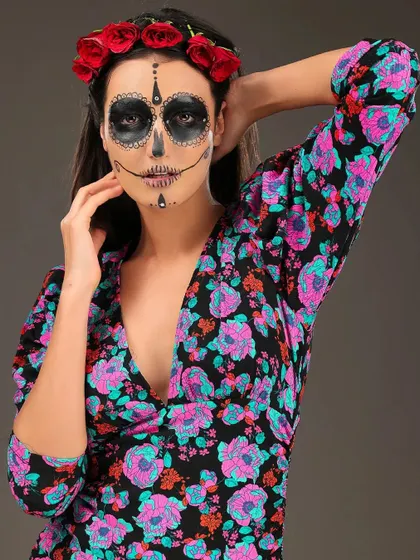 A beautiful and spooky look for Halloween, inspired by the "Day of the Dead" sugar skull makeup. The floral crown adds a touch of color to the hauntingly elegant design.