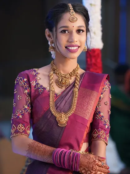 A beautiful, smiling portrait. The makeup is elegant and not overpowering, letting her natural beauty and happiness shine through.