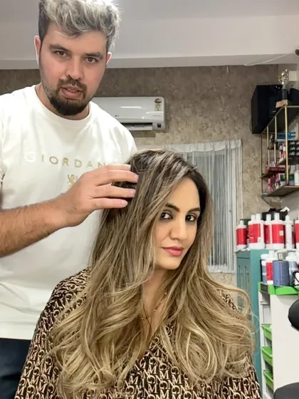 Me with a client, showcasing her stunning blonde transformation.
