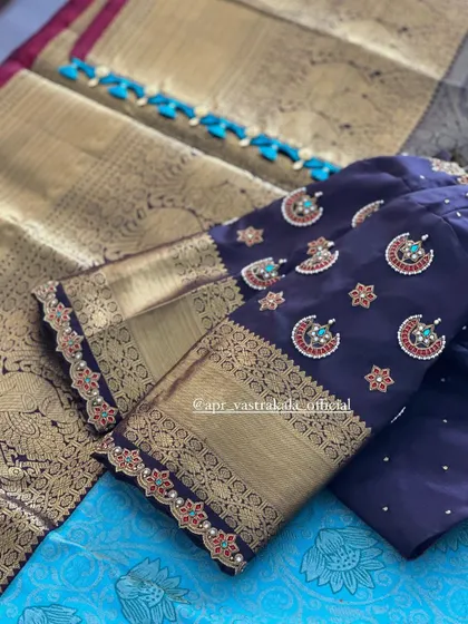 A navy blue blouse with gold brocade sleeves, featuring delicate kemp stone embroidery.
