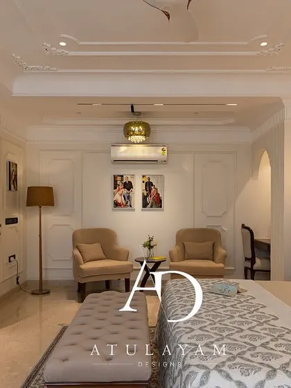 A wide shot of the master bedroom, showcasing its spacious layout with a dedicated seating area, study nook, and elegant classical details throughout.