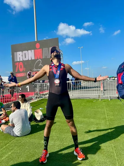 Pure elation at the Ironman 70.3 finish area. This is the reward for countless hours of swim, bike, and run training, a moment of personal triumph shared by the whole team.