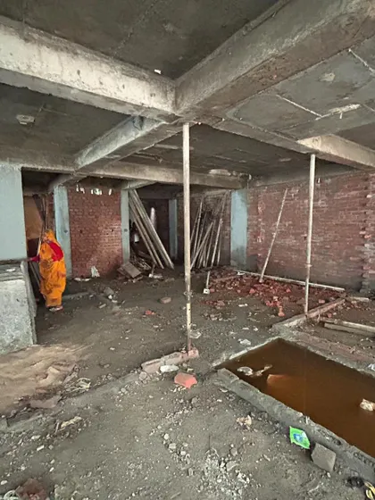 The basement level of the Mehrauli apartment complex under construction. This raw image shows the concrete columns and shuttering supports, the backbone of the multi-story structure.