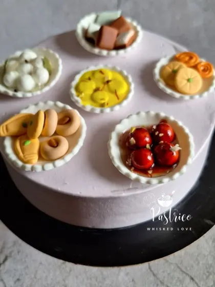 A truly unique creation, this cake is a tribute to the love for Indian sweets. It's a rich chocolate cake decorated with miniature, handcrafted fondant versions of jalebi, gulab jamun, and other mithai.