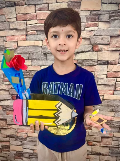 This student proudly displays the colorful pencil holder he decorated for his teacher. These functional gifts are a great way for kids to show their gratitude.
