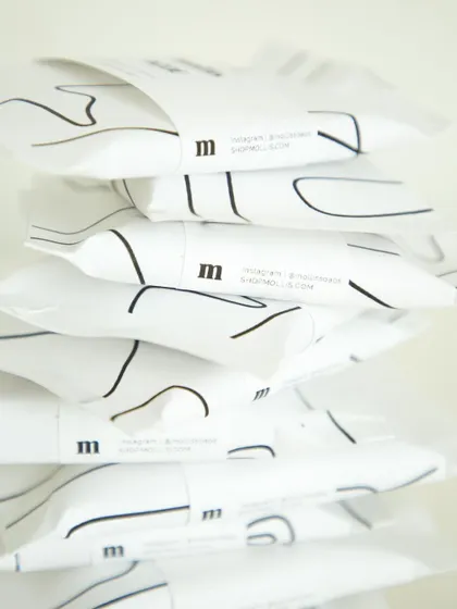 A stack of the beautifully wrapped soaps for the Airbnb ACOE team, showcasing the minimal branding.