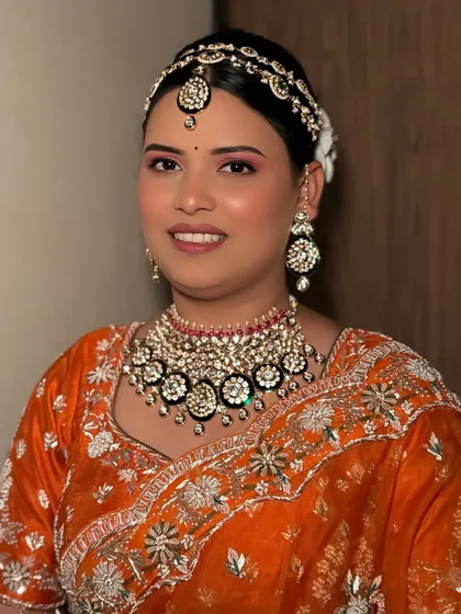 Breaking tradition with a vibrant orange lehenga. This bride wanted a bold and confident look, and we delivered with radiant glam and a pop of color on the eyes.