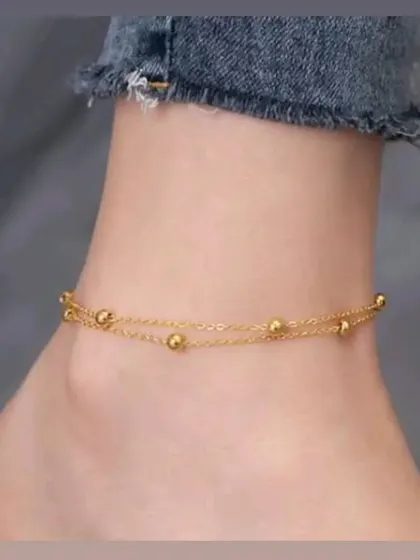 A beautiful double-chain anklet with small gold-toned beads. This piece is perfect for summer and is guaranteed to keep its vibrant color.