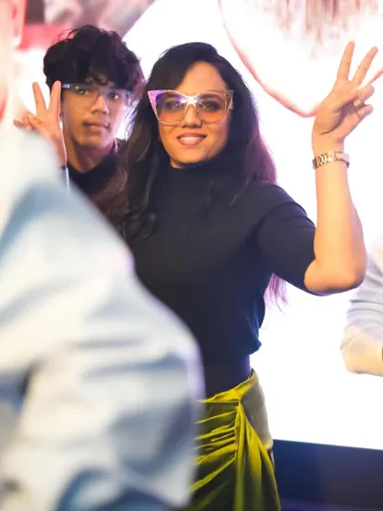 A guest with cool glasses making a peace sign, celebrating the new year in style.
