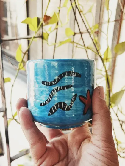 This student started with a one-time workshop and came back to begin his pottery journey. His pieces, like the quirky radio and the massive planter, are full of fun and character.