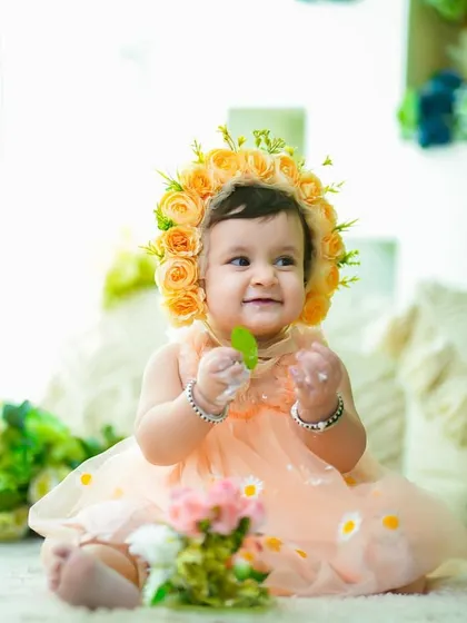 A happy baby girl in a beautiful floral bonnet after her cake smash. This is a sweet and simple way to get some clean portraits after the messy fun.