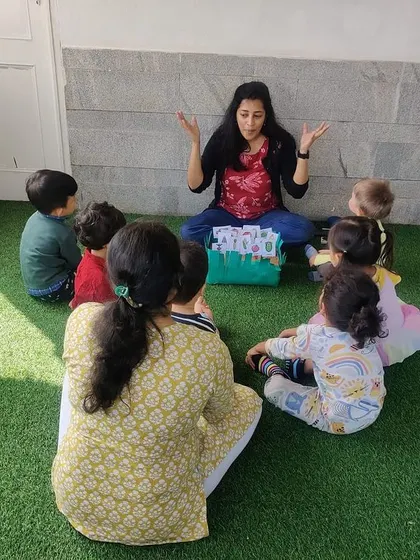 A teacher leads a story time about growing vegetables, using props to make the story interactive.