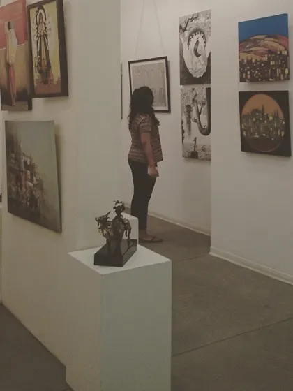 A guest explores a section of the gallery, which showcases a variety of Indian contemporary artists. Our exhibitions are curated to flow logically from one space to the next.