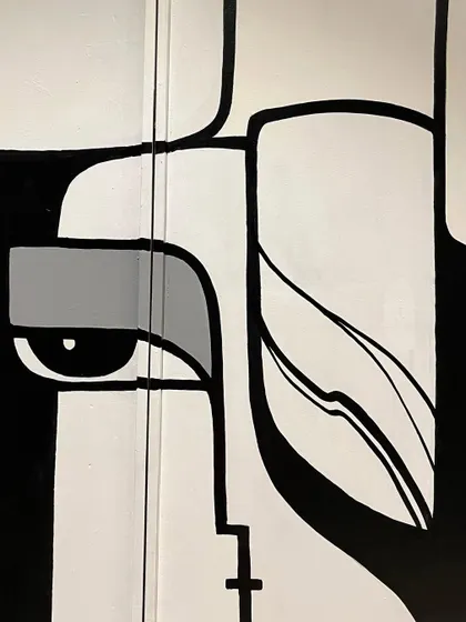 A detail shot of one of the abstract faces in the composition. The style is geometric and inspired by cubism.