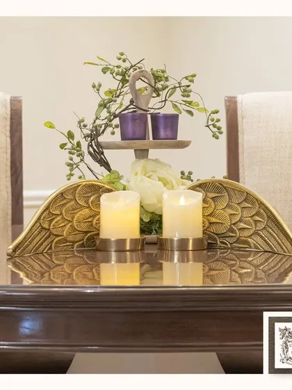 These elegant metal candleholders, shaped like angel wings, add a unique and ethereal aesthetic to a dining table. The golden finish provides a warm glow, perfect for intimate dinners.