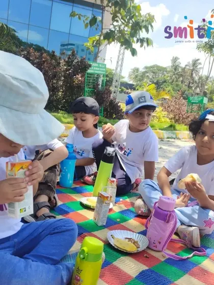 Children enjoy a picnic snack during their field trip to the lake. Taking a break to eat together is an important social part of our outdoor excursions.