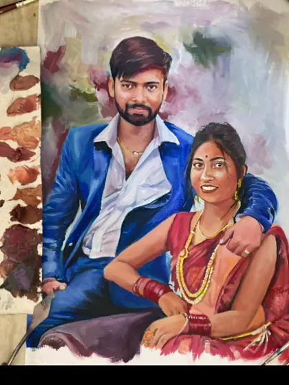 This oil painting showcases a couple in their traditional wedding outfits. The rich colors of the oil paint bring out the vibrancy of the blue suit and red saree, creating a striking portrait.