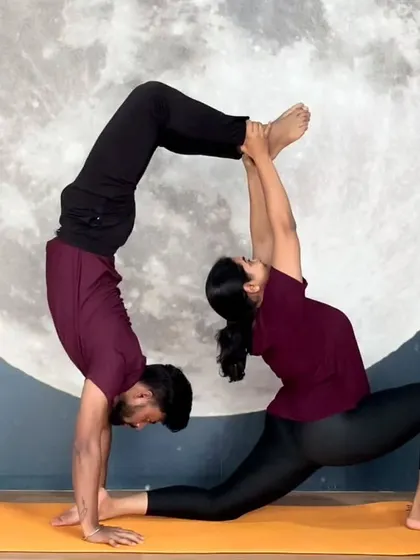 Partner yoga is about trust, balance, and creating beautiful shapes together. This Acro Yoga pose showcases the strength and connection we build in our community.