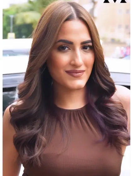 A beautiful portrait of a client showing off her new hair color and style.